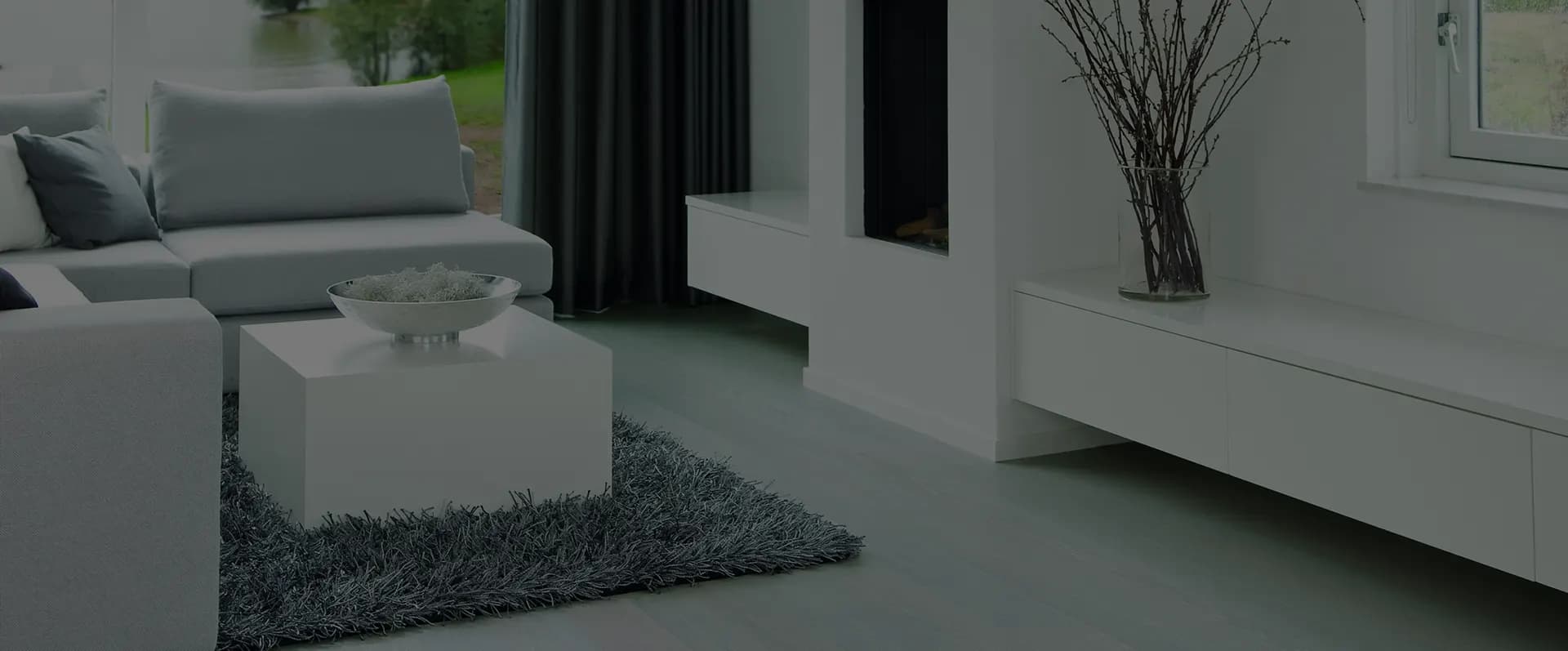 Helles Wohnzimmer mit weißer Sofalandschaft, Kamin und Sideboard