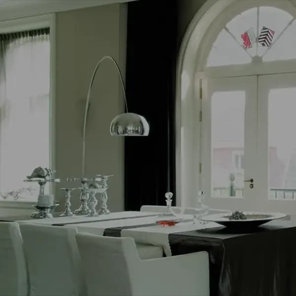 Klassisches Esszimmer mit Bogenfenster, weißer Flügeltür und Bogenlampe